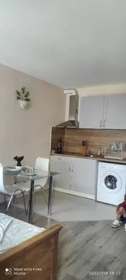 a kitchen with a table and a sink and a stove at Amber Beach in Sunny Beach