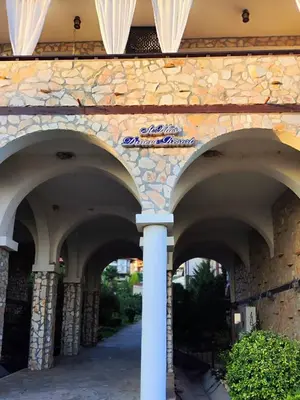 a building with arches on the side of it at Pecani Perla Del Mar - Coastal Art Residence in Sveti Vlas