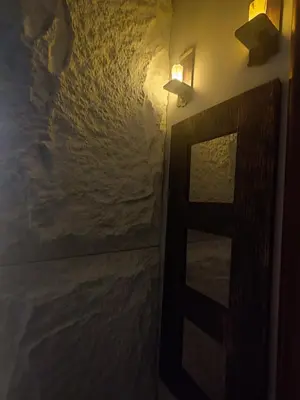 a room with a door and a lamp and a wall at Pecani Perla Del Mar - Coastal Art Residence in Sveti Vlas