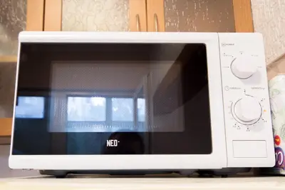a white microwave oven sitting on top of a counter at Large 2 bedrooms Flat - TOP Center - in front of the Beach in Burgas City