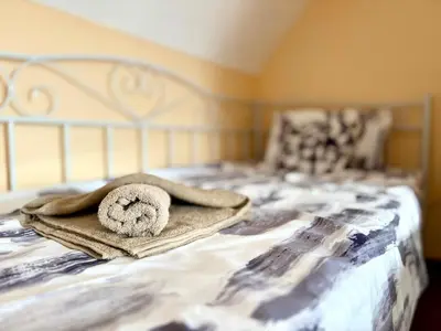 a teddy bear laying on a blanket on a bed at Varna Thermae Loft in Varna City