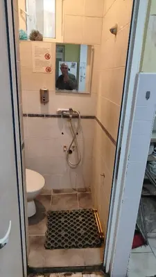 a bathroom with a shower and a toilet at Стая лидер хаус in Varna City