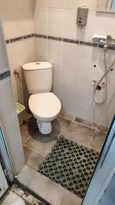 a small bathroom with a toilet and a shower at Стая лидер хаус in Varna City