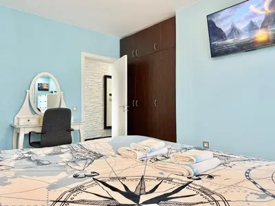 a bedroom with a bed with a mirror and a chair at SeaSky SmartHome-Penthouse with private Parking in Burgas City