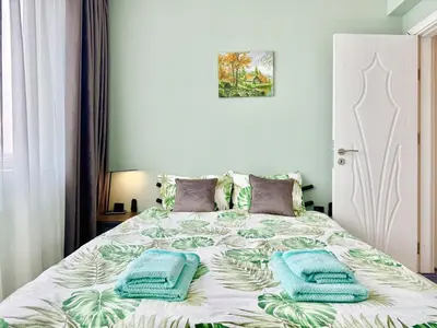 a bedroom with a bed with two towels on it at SeaSky SmartHome-Penthouse with private Parking in Burgas City
