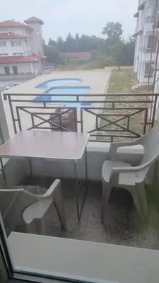 a view of a table and chairs from a window at Apartment Photinia in Byala