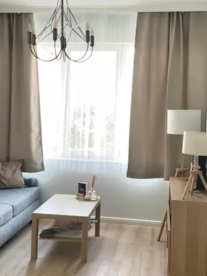 a living room with a coffee table and a window at Nearby the Sea- Elegant Retreat in Varna in Varna City