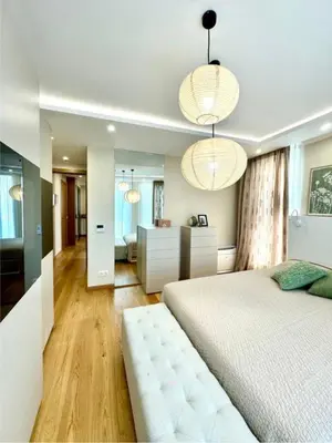 a bedroom with a white bed and two lights at Azure View in Burgas City