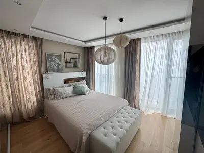 a bedroom with a white bed and large windows at Azure View in Burgas City