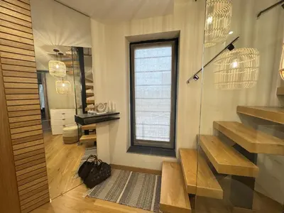 a bathroom with stairs and a window and a mirror at Azure View in Burgas City