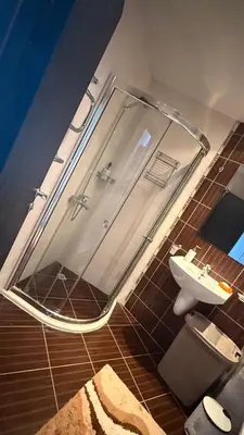 a bathroom with a shower and a sink at Atlantis Resort in Burgas City