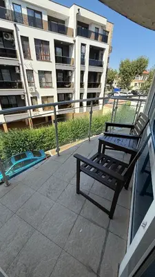 a bench sitting on a balcony in front of a building at Atlantis Resort in Burgas City