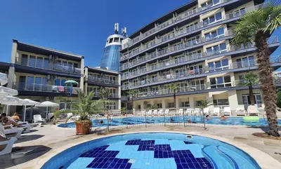 a large hotel with a swimming pool in front of a building at Sol e Mar Deluxe Apartment in Sunny Beach