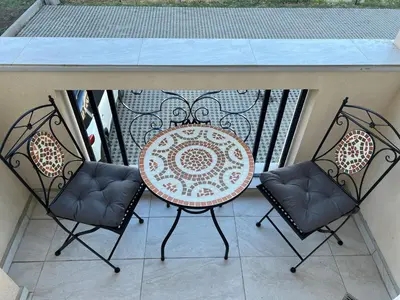 a table and two chairs on a patio at Студия Магнолия 6, Солнечный берег Болгария in Sunny Beach