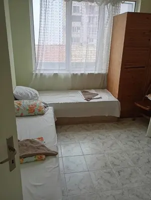 a room with a window with a bed in front of it at Апартамент планина in Varna City