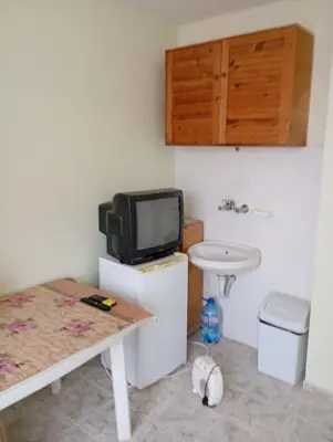 a bathroom with a tv and a toilet and a sink at Апартамент планина in Varna City