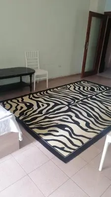 a zebra rug on the floor in a room at Апартамент център in Varna City