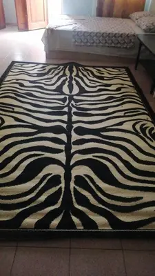 a zebra print rug on the floor in a room at Апартамент център in Varna City