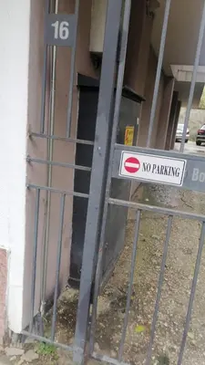 a no parking sign on a gate in front of a building at Апартамент център in Varna City
