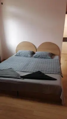 a bed with two pillows on top of it at Апартамент център in Varna City