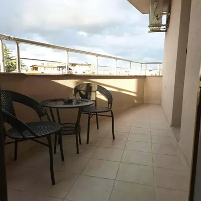 a balcony with chairs and a table on a balcony at Paradise in Burgas City
