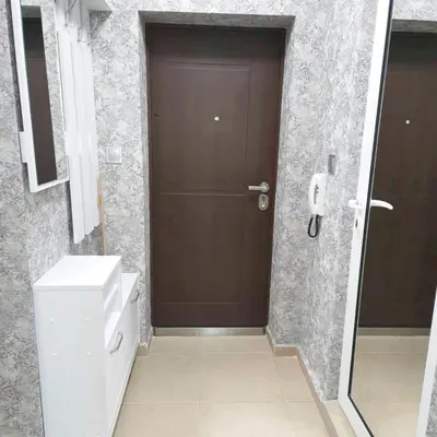 a bathroom with a toilet and a brown door at Paradise in Burgas City
