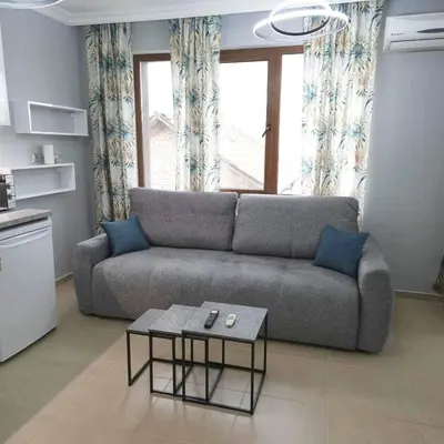 a living room with a couch and a table at Paradise in Burgas City