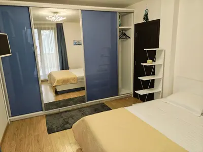 a bedroom with a mirror and a bed and a bed sqor at Trend Apart in Burgas City