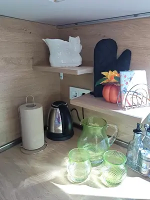 a shelf with various glass items on a table at Trend Apart in Burgas City