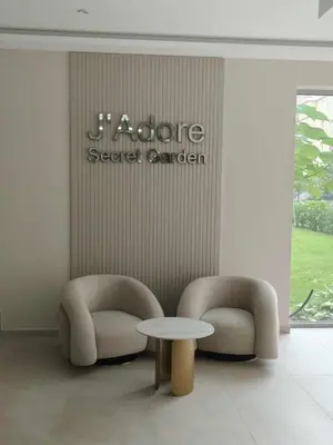 a lobby with two chairs and a table and a sign at J'Adore Secret Garden, Deluxe Apartment in Sunny Beach