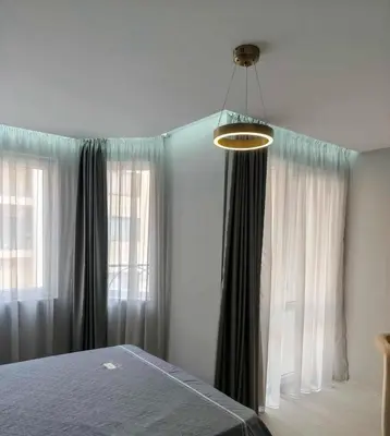 a bedroom with a bed and two large windows at J'Adore Secret Garden, Deluxe Apartment in Sunny Beach