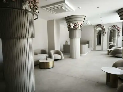 a lobby with columns and a table and chairs at J'Adore Secret Garden, Deluxe Apartment in Sunny Beach