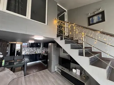 a staircase in a house with christmas lights at Комфорт и стиль - Апартамент с панорамой города in Burgas City