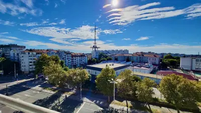 a view of a city with a tv tower at Комфорт и стиль - Апартамент с панорамой города in Burgas City