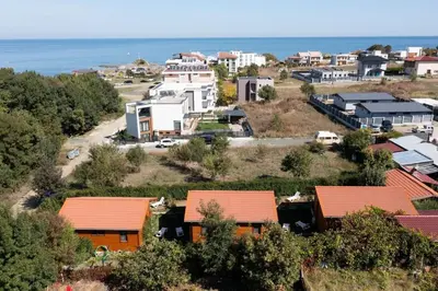 a small town with houses and the ocean at Бунгала Гнездото Bungalows The Nest Lozenets 2 in Lozenets