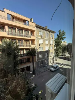a view of a building with a car parked in a parking lot at Sun in Varna City