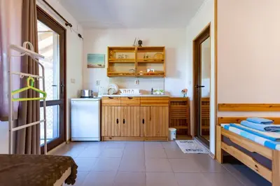 a kitchen with a sink and a refrigerator at Бунгала Гнездото Bungalows The Nest 1 in Lozenets