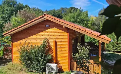 a small log cabin with a red roof at Бунгала Гнездото Bungalows The Nest 1 in Lozenets