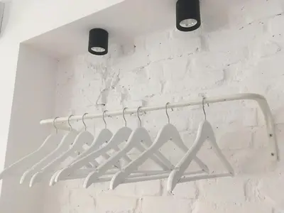 a white towel rack hanging on a white brick wall at The Corner Studio in Varna City
