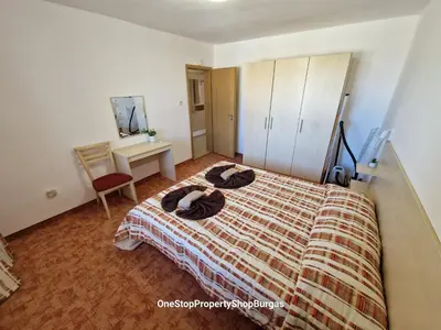 a bedroom with a bed and a desk and a mirror at Ravda Holiday Village 1-bed seaview apartment in Ravda