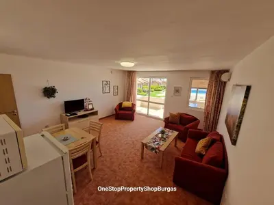 a living room with a couch and a table at Ravda Holiday Village 1-bed seaview apartment in Ravda