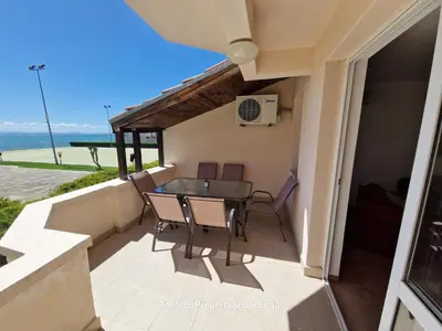 a balcony of a house with a table and chairs at Ravda Holiday Village 1-bed seaview apartment in Ravda