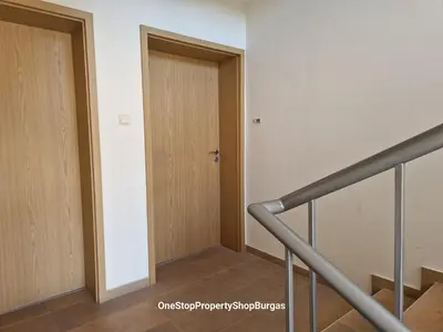 a hallway with a wooden door and stairs at Ravda Holiday Village 1-bed seaview apartment in Ravda