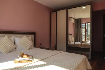 a bedroom with a bed with a tray of fruit on it at Central Varna Stay with Free Parking by ApartMAX in Varna City