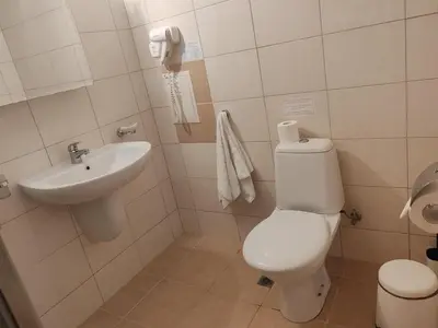 a bathroom with a toilet and a sink at Апартамент E003 в Обзор Бийч Резорт - усещането да живееш на плажа !!! in Obzor