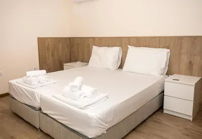 a bed with two white towels on top of it at Casa Novara Apartments - Relax & Enjoy in Central Varna by Flat Mаnаger in Varna City