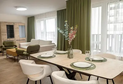 a dining room with a table and chairs at Casa Novara Apartments - Relax & Enjoy in Central Varna by Flat Mаnаger in Varna City