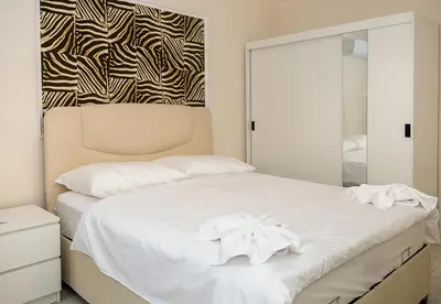 a bedroom with a white bed and a mirror at Casa Novara Apartments - Relax & Enjoy in Central Varna by Flat Mаnаger in Varna City
