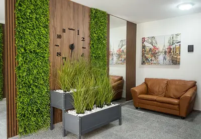 a lobby with a couch and a green wall at Casa Novara Apartments - Relax & Enjoy in Central Varna by Flat Mаnаger in Varna City