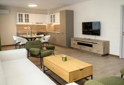 a living room with a couch and a table at Casa Novara Apartments - Relax & Enjoy in Central Varna by Flat Mаnаger in Varna City